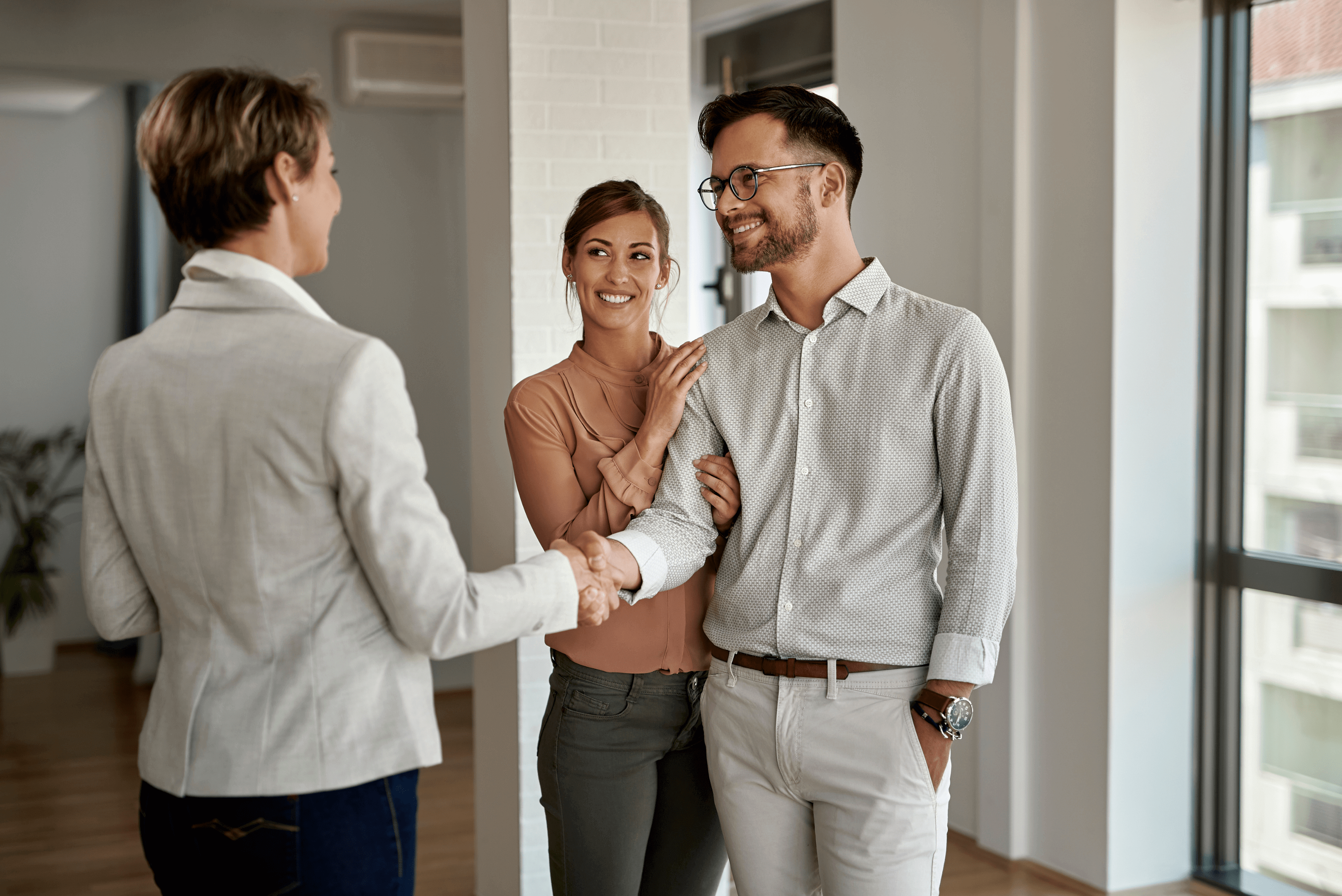 A real estate agent shaking hands with a seller